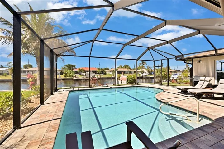 Pool with a water view, a lanai, and a patio area