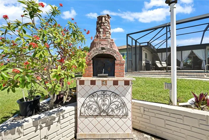View of patio with a lanai and an outdoor brick pizza oven ( no warranty on current use) although previous owner did cook pizza for passing boaters