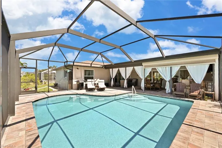 Pool with screen enclosure and a patio