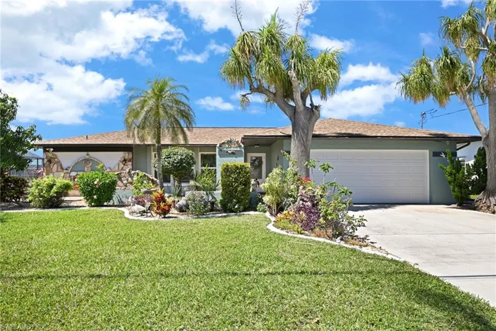 Ranch-style house featuring stucco siding, an attached garage, concrete driveway, oversized garage with entry to laundry room and Master suite #2