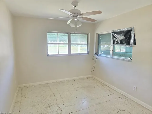 Spare room with baseboards and ceiling fan
