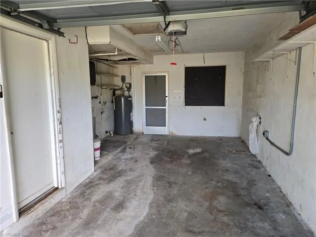 Garage with electric water heater and a garage door opener