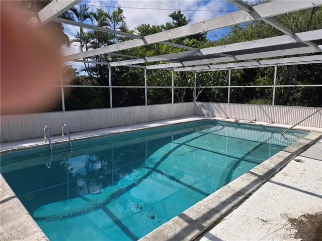 Swimming pool with a lanai and a patio