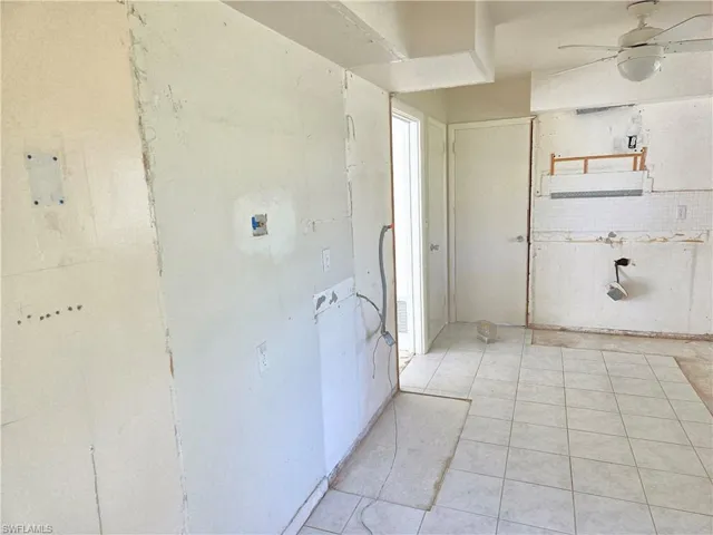 Corridor with light tile patterned floors