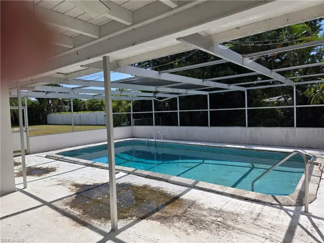 View of pool featuring a lanai and a patio area