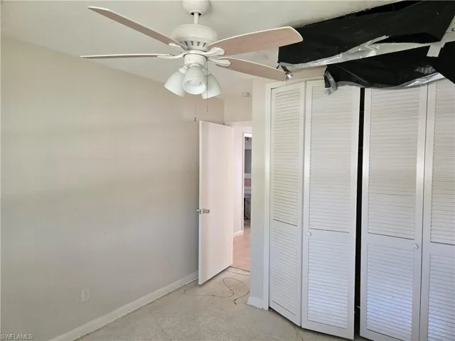 Unfurnished bedroom featuring a ceiling fan and a closet