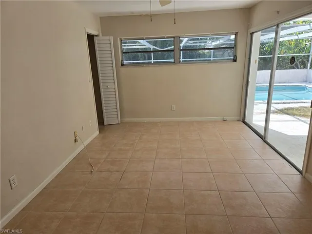 Unfurnished room featuring light tile patterned floors and baseboards