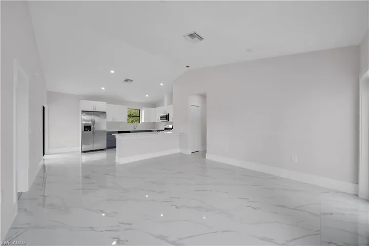 Open-concept living space with large format porcelain tile flooring