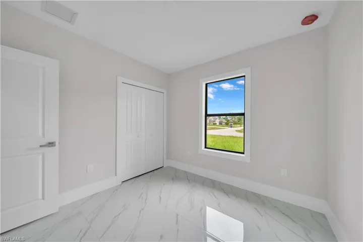 Light-toned walls, white trim, and glossy tile flooring