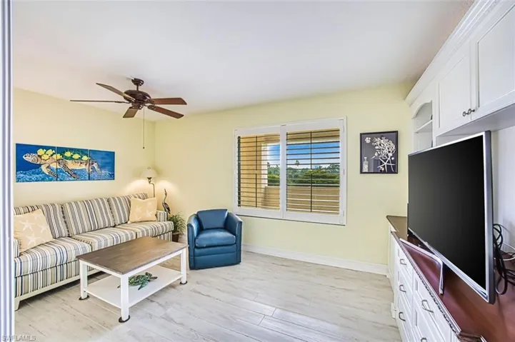 Living room featuring light wood-type flooring and ceiling fan