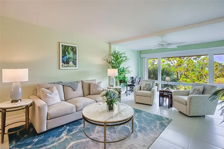 Living area with a ceiling fan and tile patterned flooring