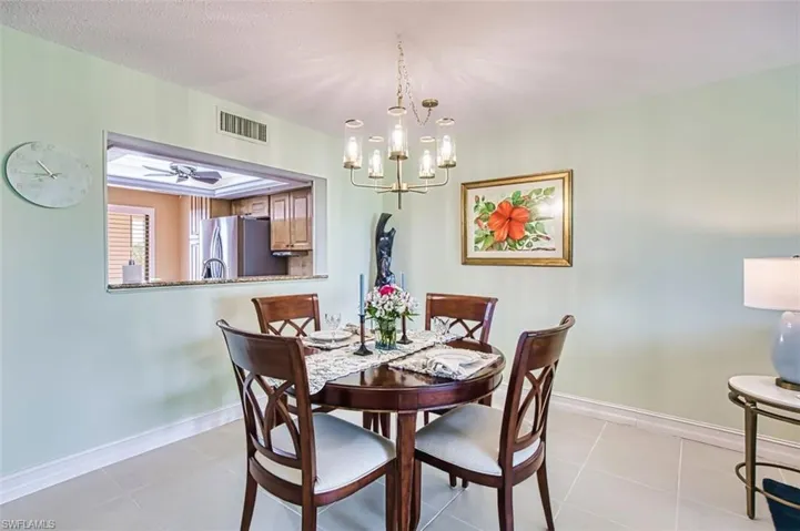 Dining room with a chandelier and light tile patterned floors