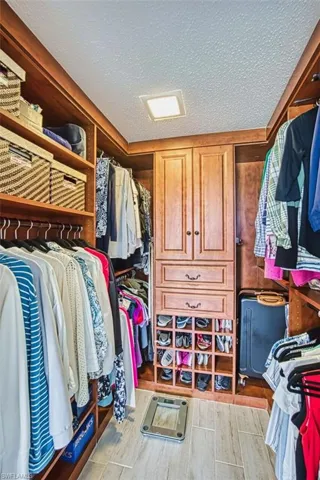 Spacious closet featuring wood finish floors