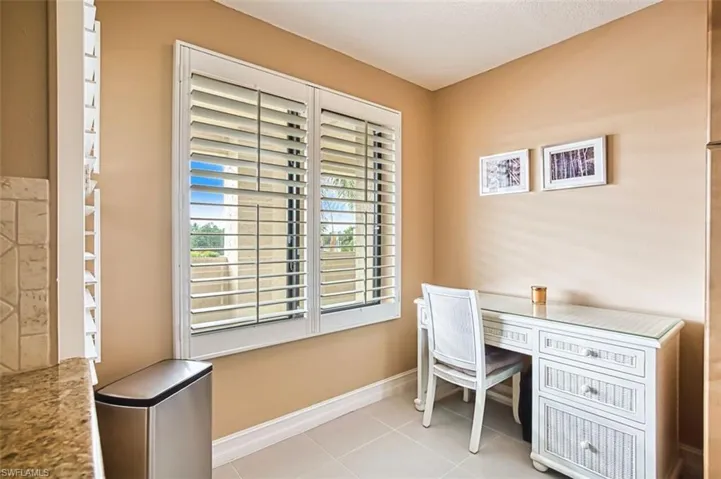 Home office with baseboards and light tile patterned flooring