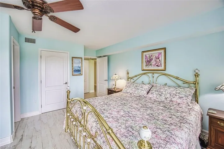 Bedroom featuring a closet, a ceiling fan, and light wood-style flooring