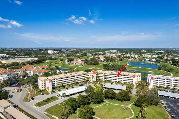 Aerial view of a golf course and a nearby body of water