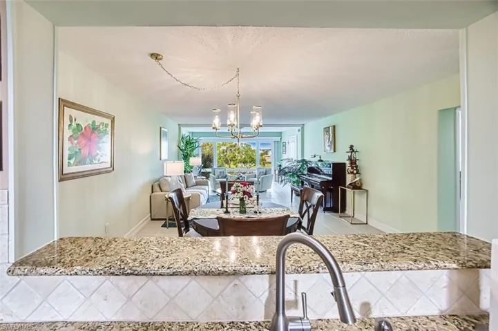 Dining area featuring light tile patterned flooring and a chandelier