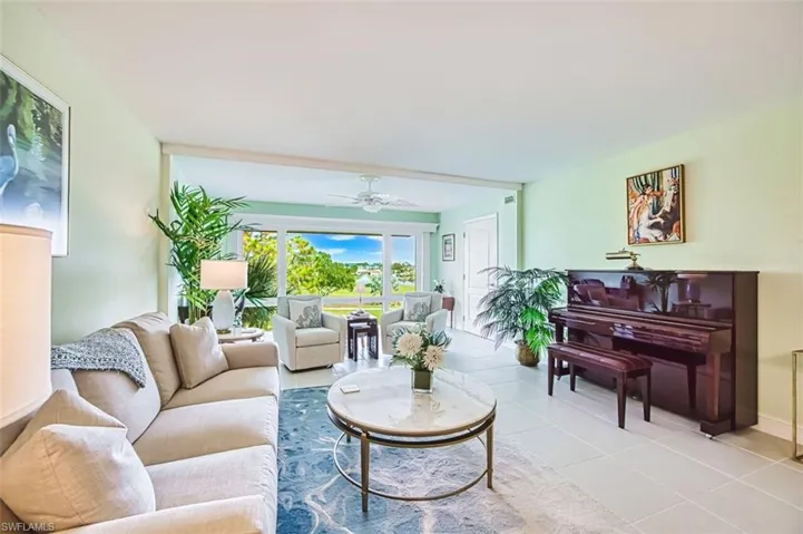 Living area with ceiling fan and tile patterned floors