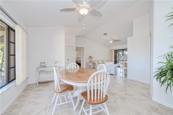 Dining room with ceiling fan and lofted ceiling