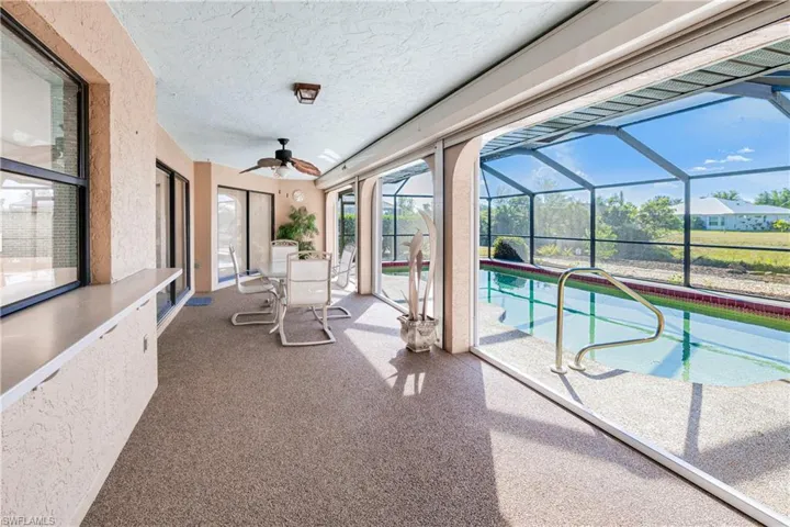 View of pool with ceiling fan