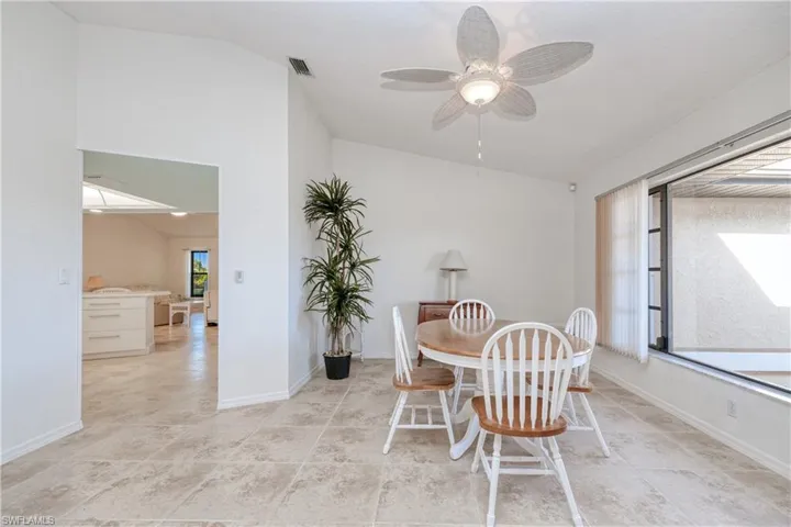 Dining space with ceiling fan, a healthy amount of sunlight, and lofted ceiling