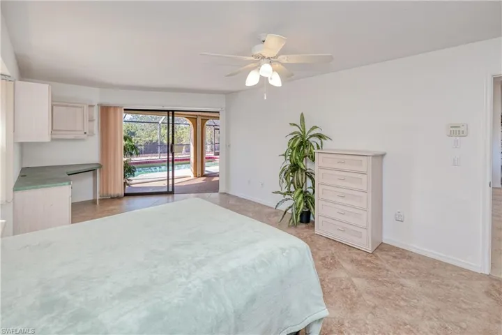 Bedroom featuring access to exterior and ceiling fan