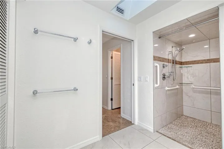 Bathroom featuring tile patterned flooring and tiled shower