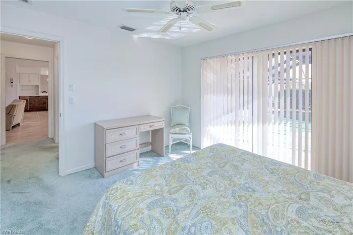 Bedroom featuring ceiling fan and light colored carpet