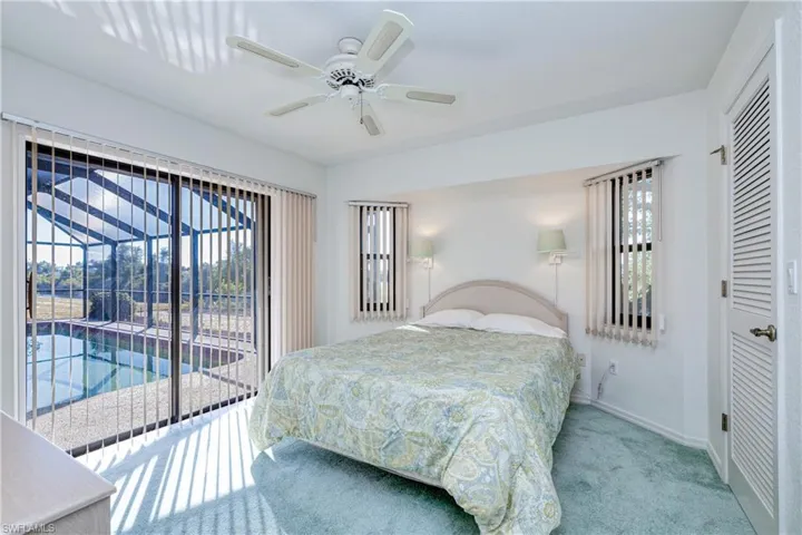 Bedroom featuring access to exterior, ceiling fan, a closet, and carpet