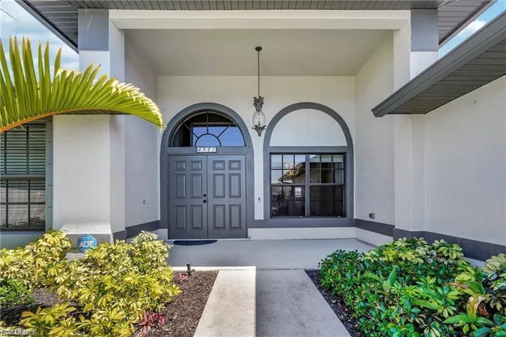Property entrance with stucco siding and a porch