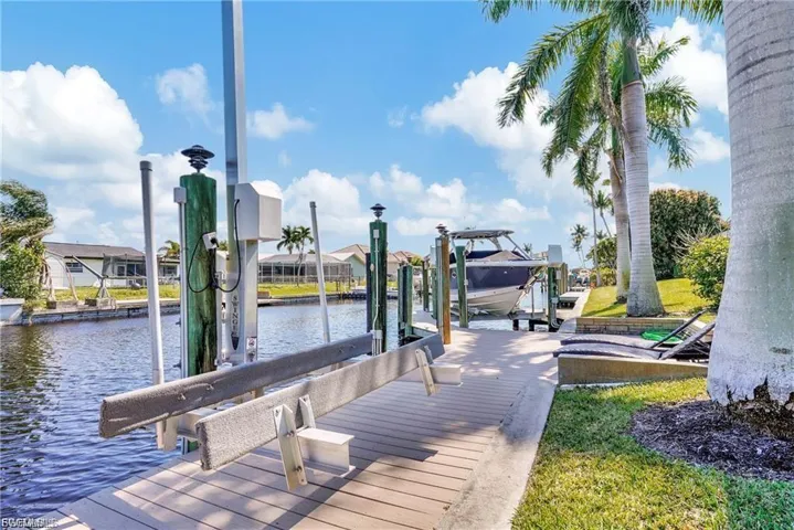 Dock with boat lift and a water view