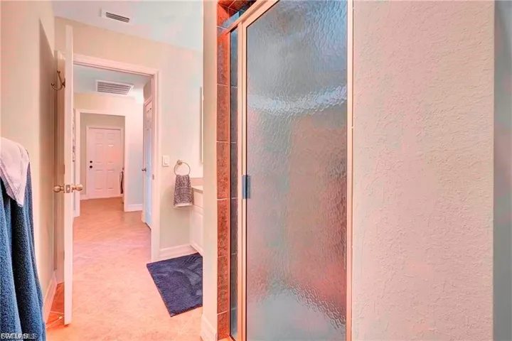 Bathroom featuring a stall shower and light tile patterned floors