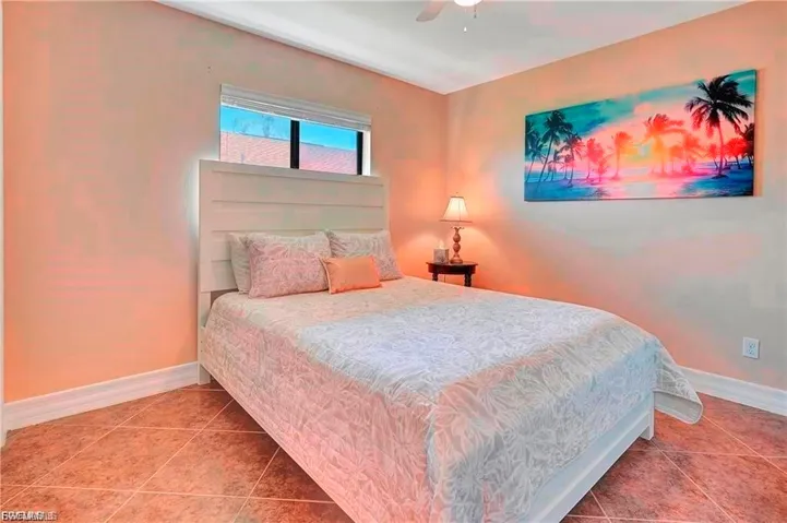 Bedroom featuring ceiling fan and tile patterned flooring