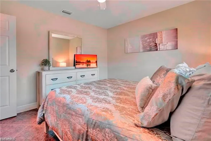 Bedroom featuring baseboards and tile patterned flooring