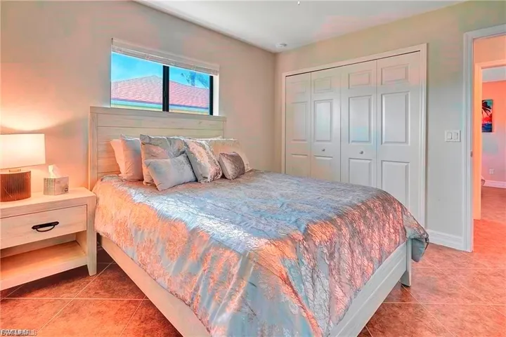 Bedroom featuring a closet and light tile patterned floors