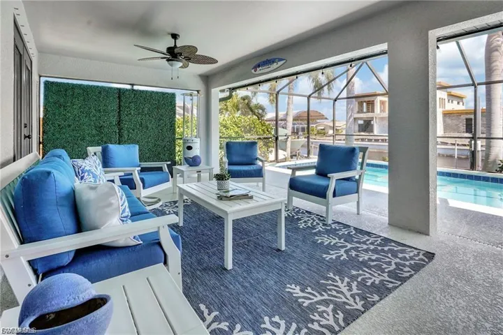 Sunroom with an outdoor hangout area, ceiling fan, a patio, and a swimming pool
