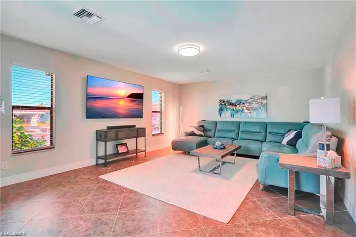 Tiled living room featuring baseboards