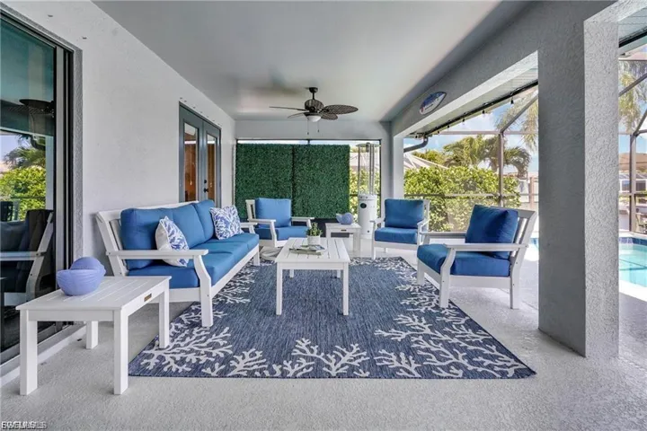 View of patio / terrace featuring ceiling fan, glass enclosure, an outdoor hangout area, a sunroom, and french doors