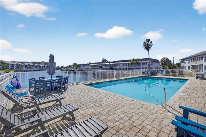 Community pool featuring a patio area and outdoor dining area