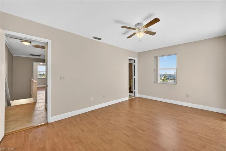 Empty room featuring light wood finished floors and ceiling fan