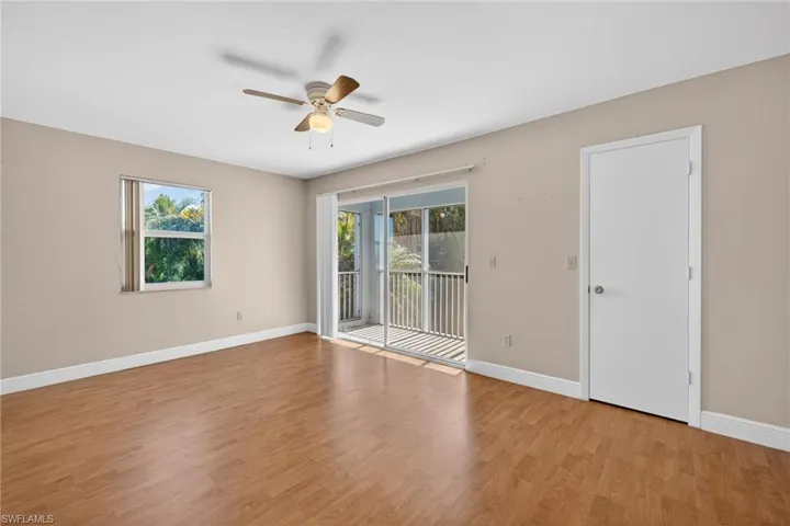 Unfurnished room featuring light wood-type flooring, healthy amount of natural light, and ceiling fan