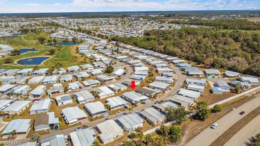 Aerial perspective of suburban area featuring a nearby body of water