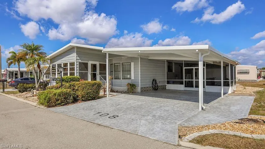 Rear view of house featuring a sunroom