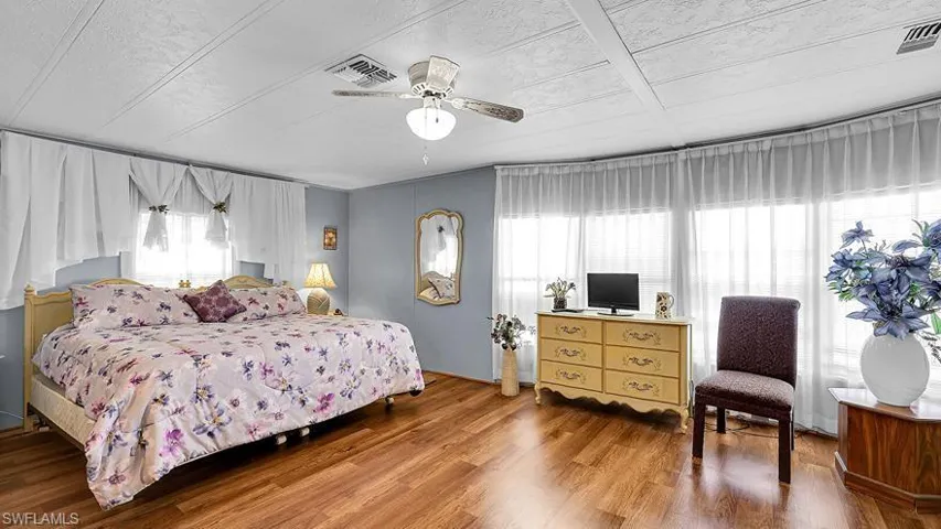 Bedroom featuring wood finished floors and a ceiling fan
