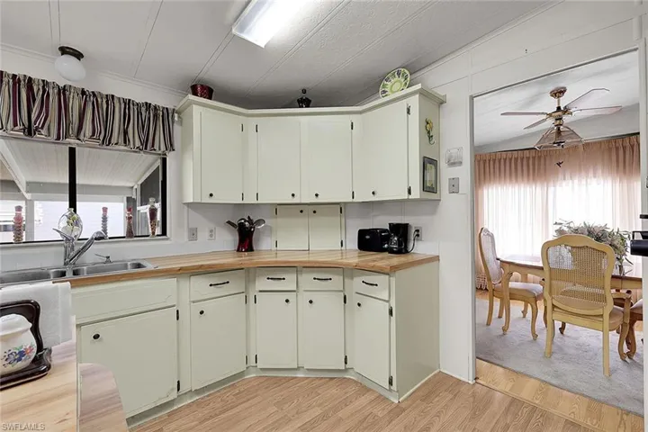 Kitchen featuring ceiling fan, light wood-type flooring, and healthy amount of natural light