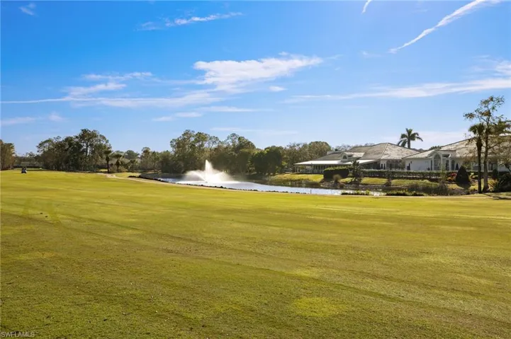 Surrounding community featuring a water view and a lawn