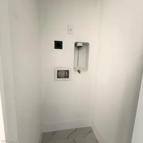 Laundry area with hookup for a washing machine and hookup for an electric dryer