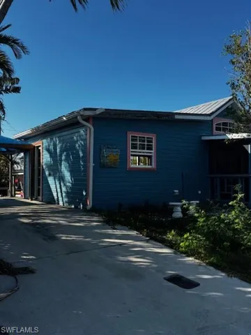 View of side of home featuring driveway