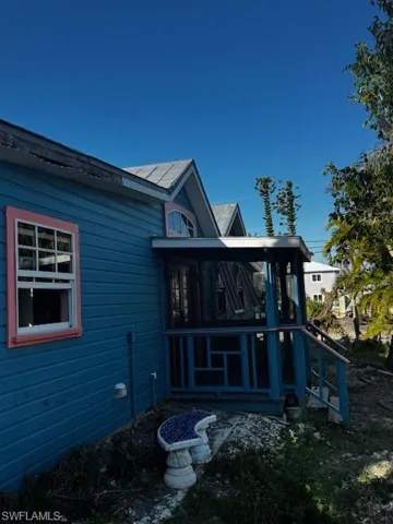 Back of house featuring a sunroom