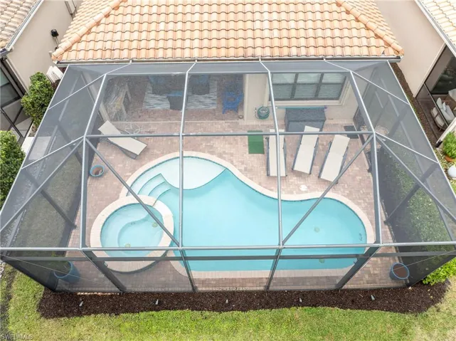 Swimming pool with a sunroom and a lanai